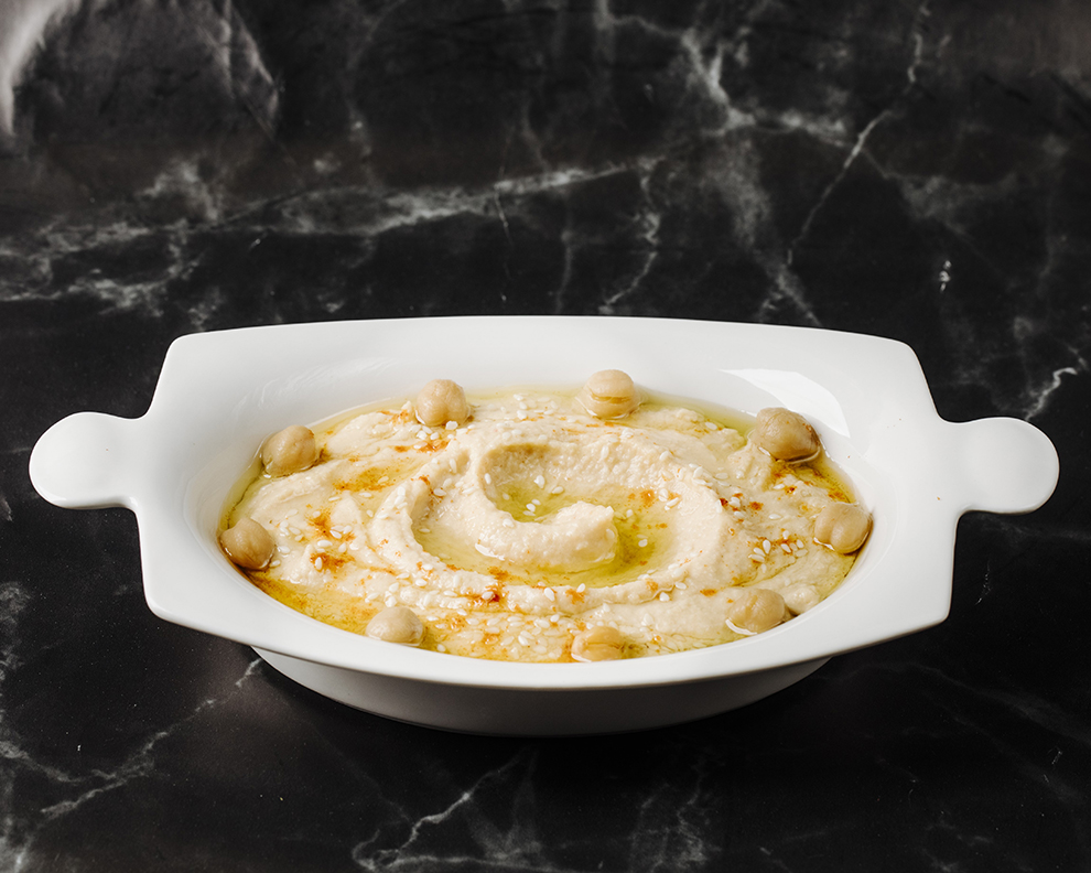 arabic-apetizer-humus-with-nuts-inside-white-plate-black-marble